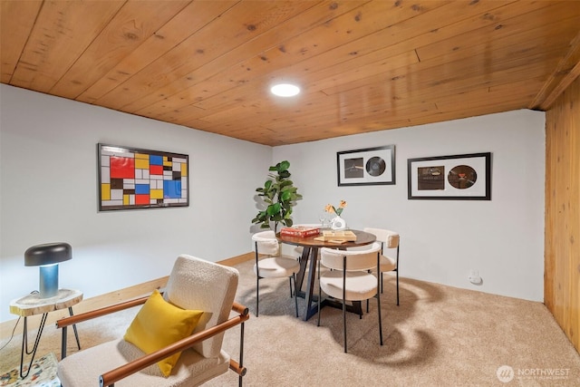 dining space featuring carpet floors and wooden ceiling