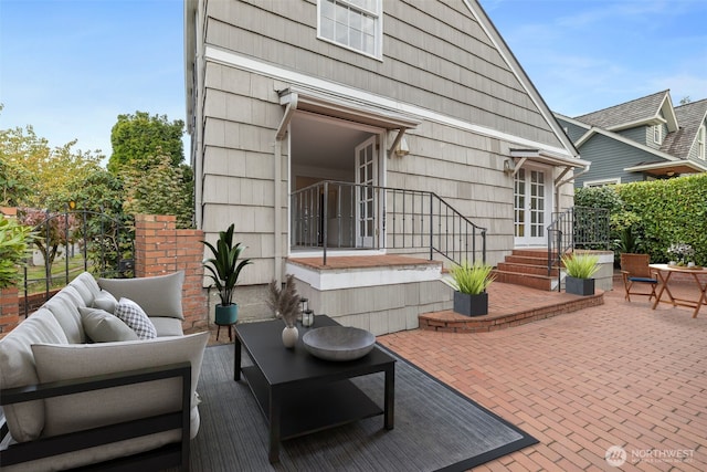 rear view of house with a patio and an outdoor living space