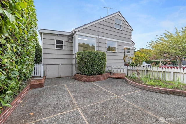 back of house featuring a patio area and fence