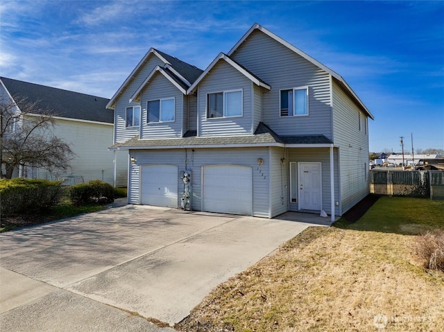 view of front facade with a garage, fence, concrete driveway, and a front yard