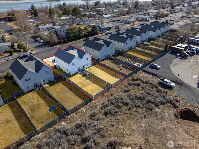 birds eye view of property featuring a water view and a residential view