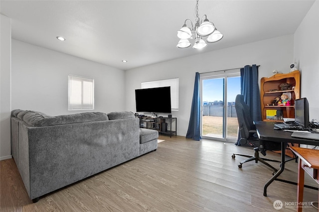 living room with a chandelier, recessed lighting, baseboards, and wood finished floors