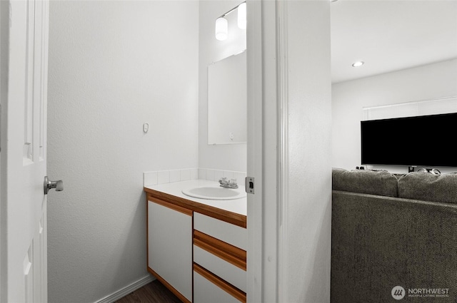 bathroom with vanity and baseboards