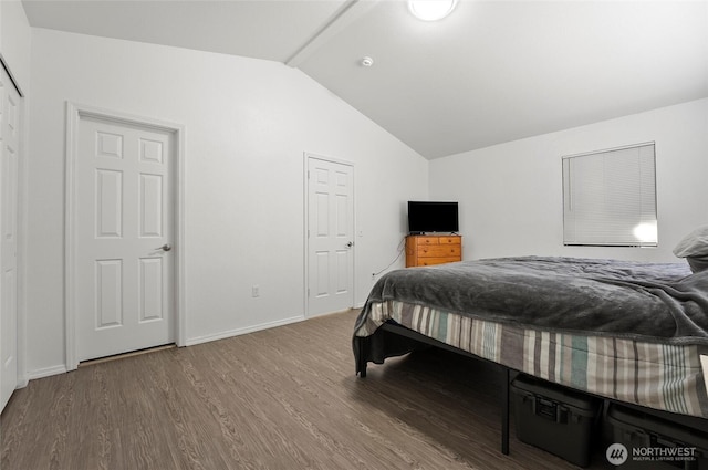 bedroom with vaulted ceiling, baseboards, and wood finished floors