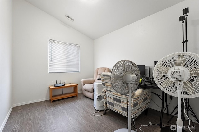 living area with lofted ceiling, wood finished floors, visible vents, and baseboards