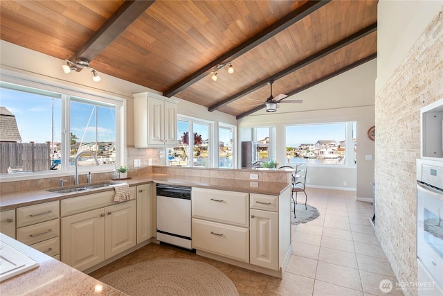 kitchen with light tile patterned flooring, a peninsula, a sink, wood ceiling, and dishwasher