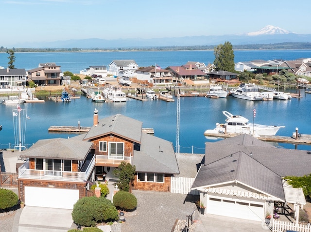 drone / aerial view with a water view and a residential view