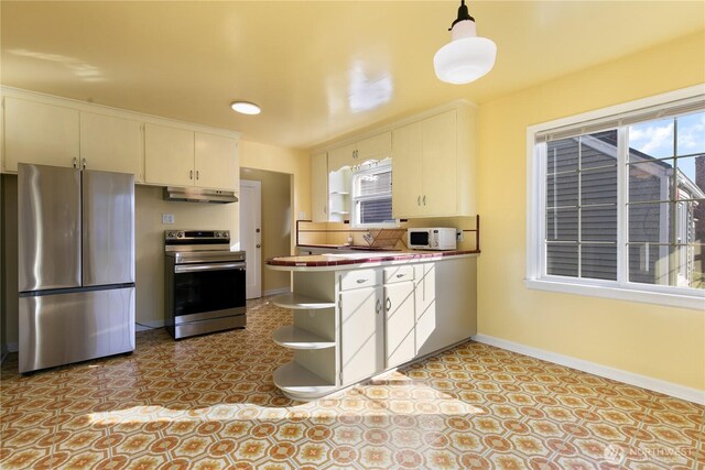 kitchen featuring under cabinet range hood, open shelves, appliances with stainless steel finishes, a peninsula, and baseboards