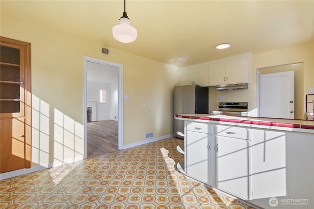 kitchen with visible vents, stainless steel appliances, tile counters, white cabinets, and under cabinet range hood