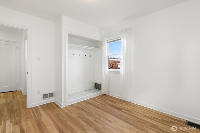 mudroom with visible vents, baseboards, and light wood-style flooring