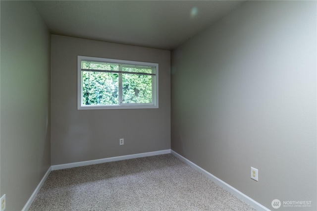 carpeted empty room with baseboards