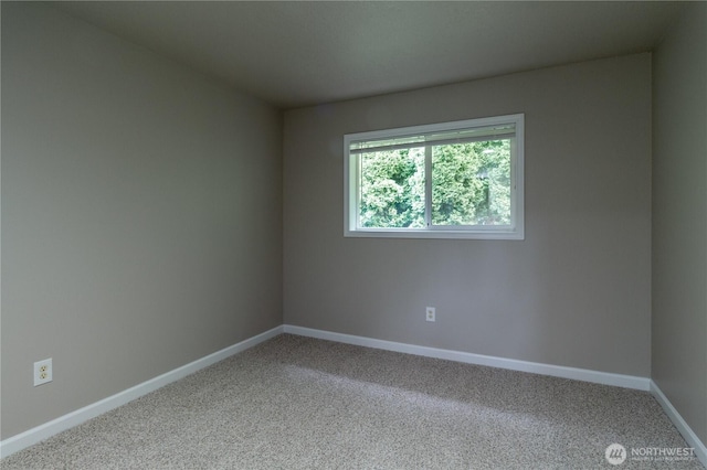 empty room featuring baseboards and carpet floors