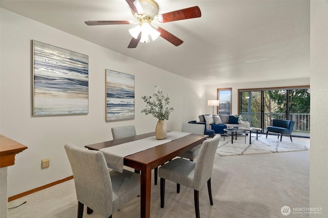 dining room with light colored carpet and baseboards