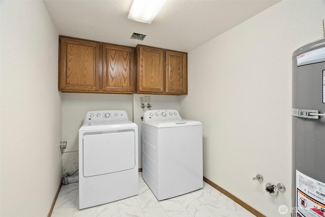 laundry area featuring marble finish floor, washer and clothes dryer, cabinet space, baseboards, and secured water heater