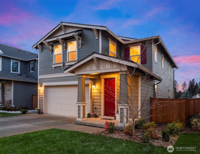 craftsman-style home with an attached garage, concrete driveway, board and batten siding, and fence