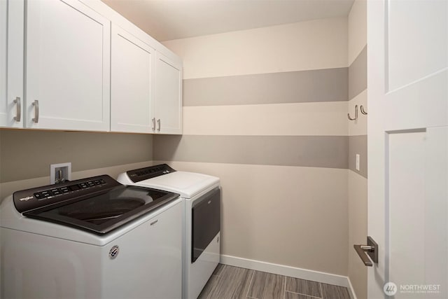 laundry area with cabinet space, independent washer and dryer, baseboards, and wood tiled floor