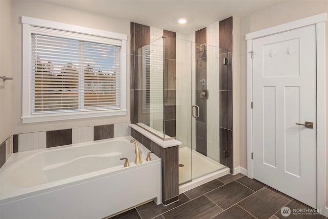 bathroom featuring a shower stall and a garden tub