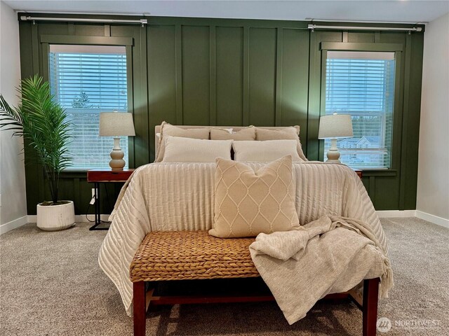 bedroom featuring a decorative wall and carpet