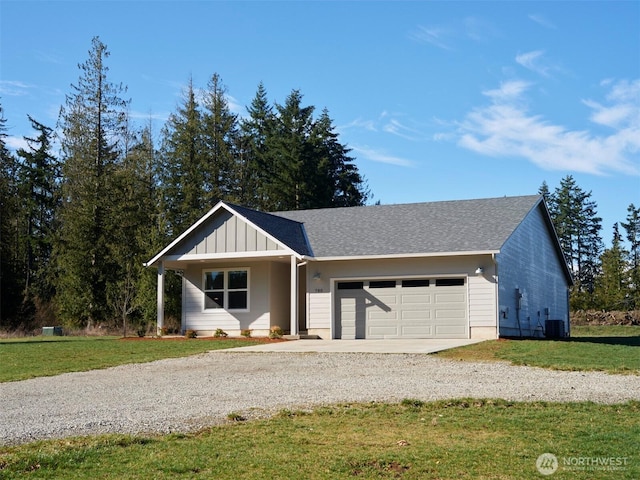 ranch-style home with gravel driveway, central air condition unit, board and batten siding, a front yard, and a garage