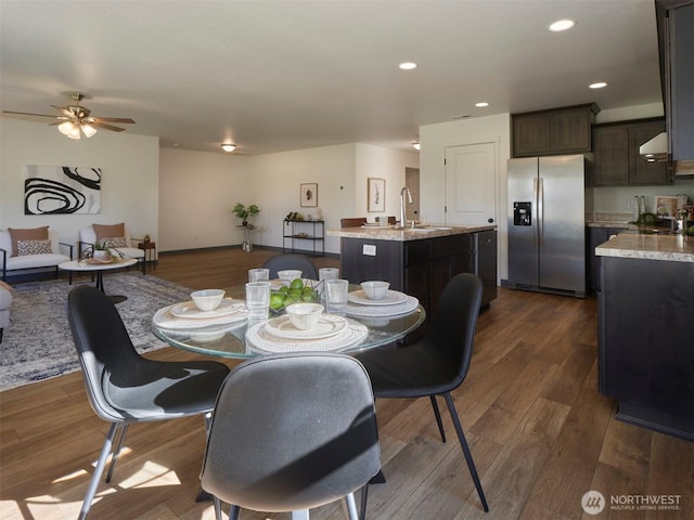 dining area featuring dark wood finished floors, a ceiling fan, and recessed lighting