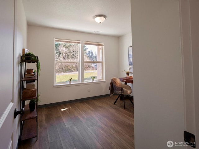 office space featuring visible vents, baseboards, and dark wood-type flooring