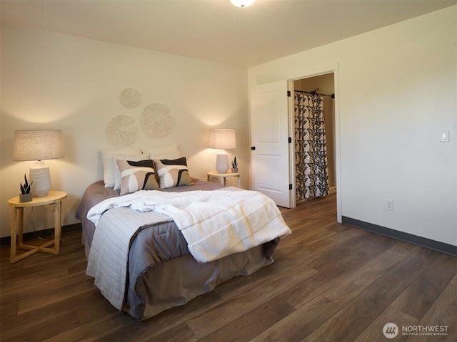 bedroom featuring wood finished floors and baseboards