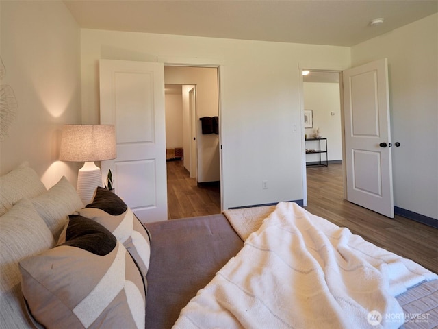 bedroom featuring baseboards and wood finished floors