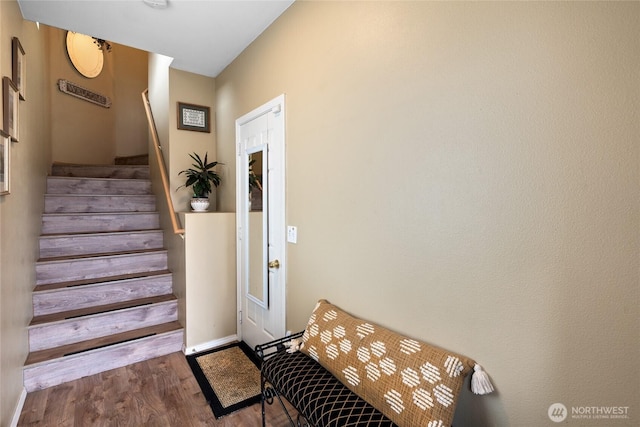 stairway featuring wood finished floors and baseboards