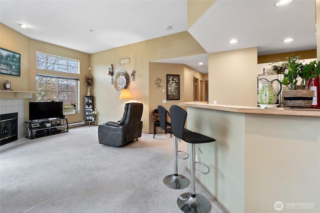 living room featuring recessed lighting, light colored carpet, and a fireplace