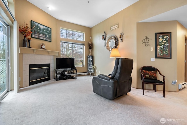 carpeted living room with a baseboard heating unit and a tile fireplace