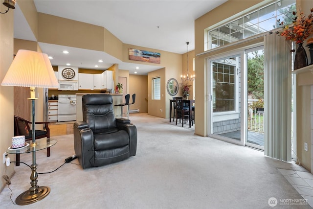 living area with a chandelier, light colored carpet, baseboard heating, recessed lighting, and a towering ceiling