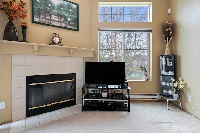 interior space with a wealth of natural light, a fireplace, and a baseboard radiator