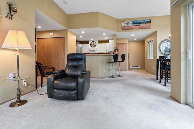 living area with recessed lighting, light colored carpet, baseboards, and baseboard heating