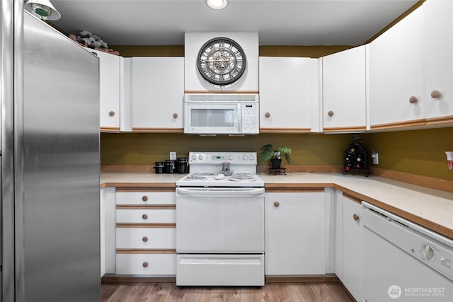 kitchen with white cabinetry, white appliances, light countertops, and light wood-type flooring