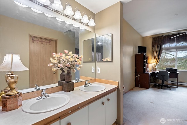 bathroom with a sink, lofted ceiling, and double vanity