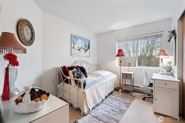 bedroom with baseboard heating and light colored carpet