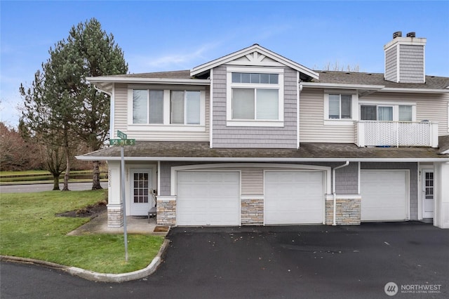 multi unit property featuring stone siding, a garage, driveway, and a shingled roof