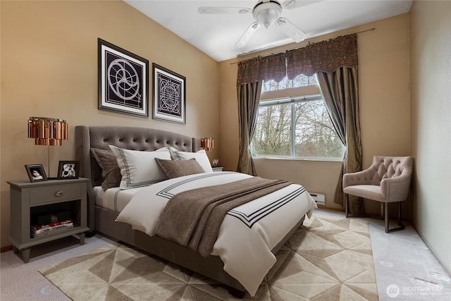 bedroom featuring light carpet, baseboards, and ceiling fan