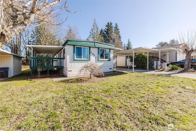 manufactured / mobile home featuring a carport, crawl space, and a front lawn