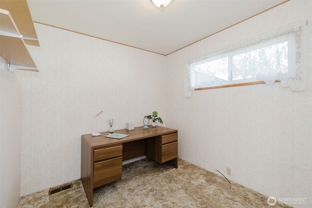 office featuring light carpet, wallpapered walls, and visible vents