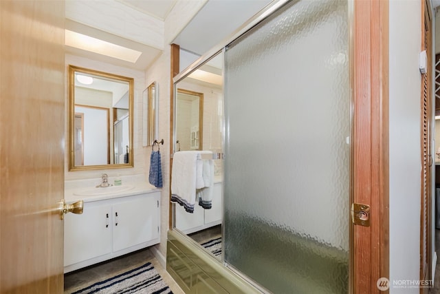 bathroom featuring an enclosed shower and vanity