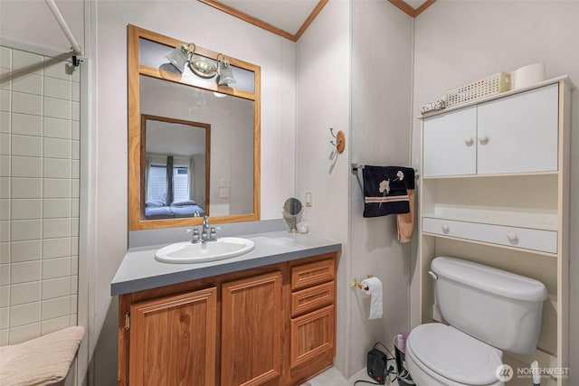 full bath with toilet, ornamental molding, and vanity