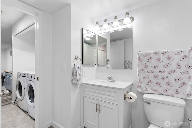 bathroom featuring toilet, vanity, and independent washer and dryer