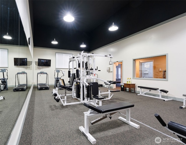 exercise room with recessed lighting and baseboards