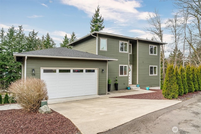 exterior space featuring entry steps, a garage, driveway, and a shingled roof