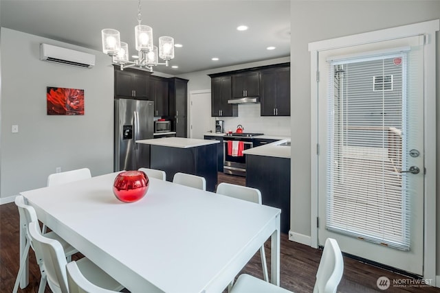 dining space with recessed lighting, a wall mounted air conditioner, dark wood-type flooring, and baseboards