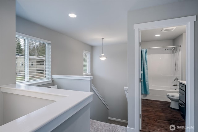 full bathroom with a wealth of natural light, visible vents, toilet, and vanity