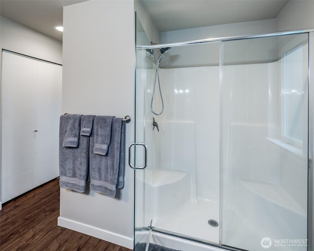 full bath featuring wood finished floors and a stall shower