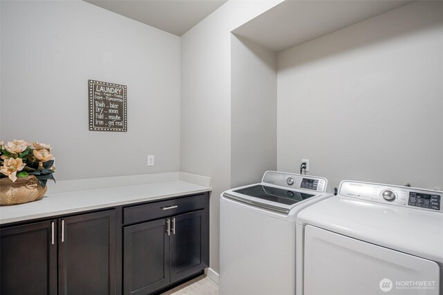 laundry room with cabinet space and separate washer and dryer