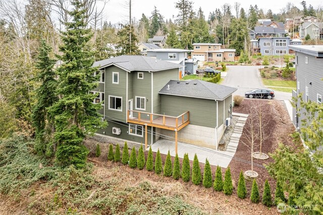 back of house with a wooden deck and a residential view